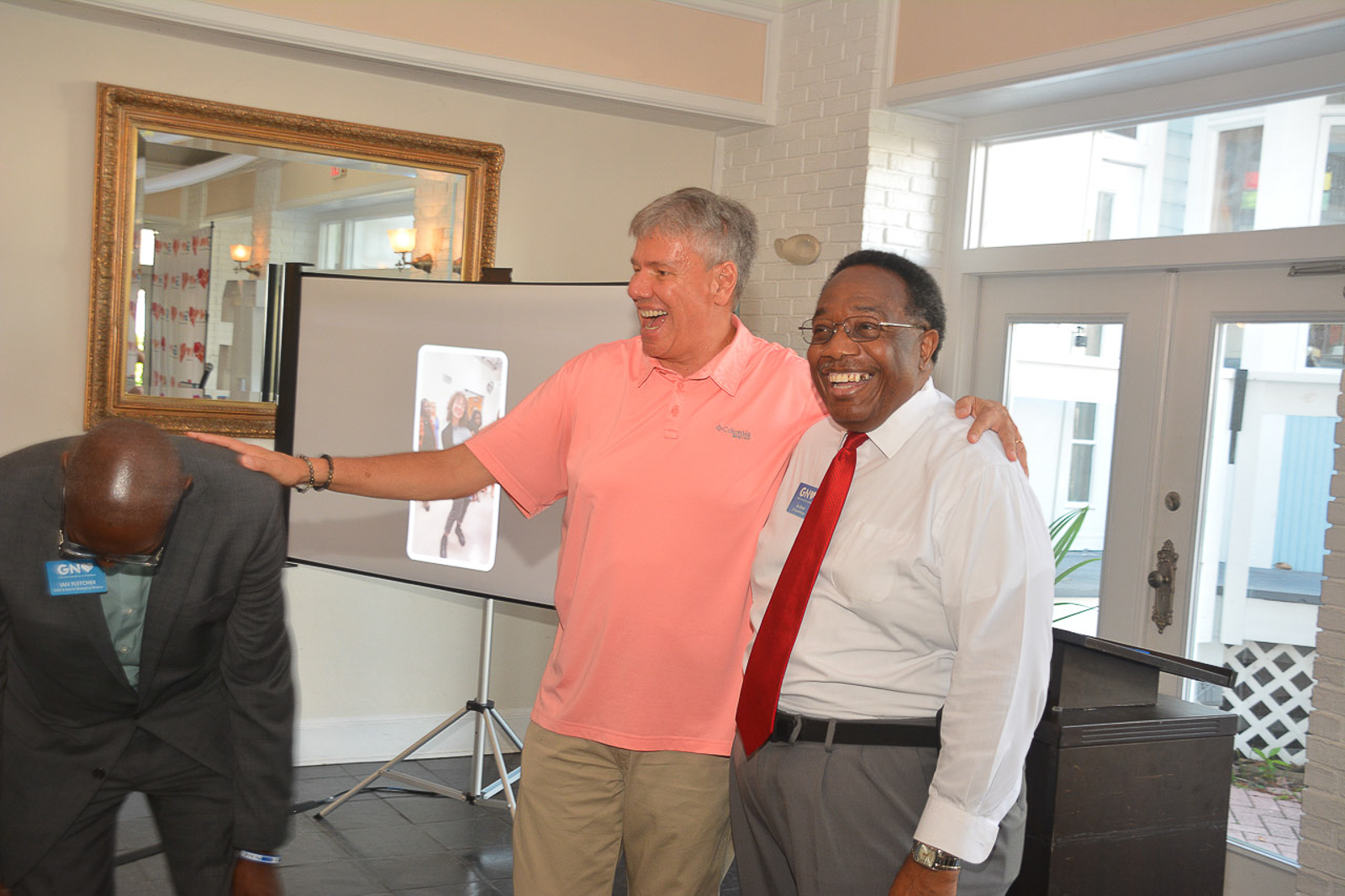 Community leaders sharing a lighthearted moment at the Leadership Gainesville graduation
