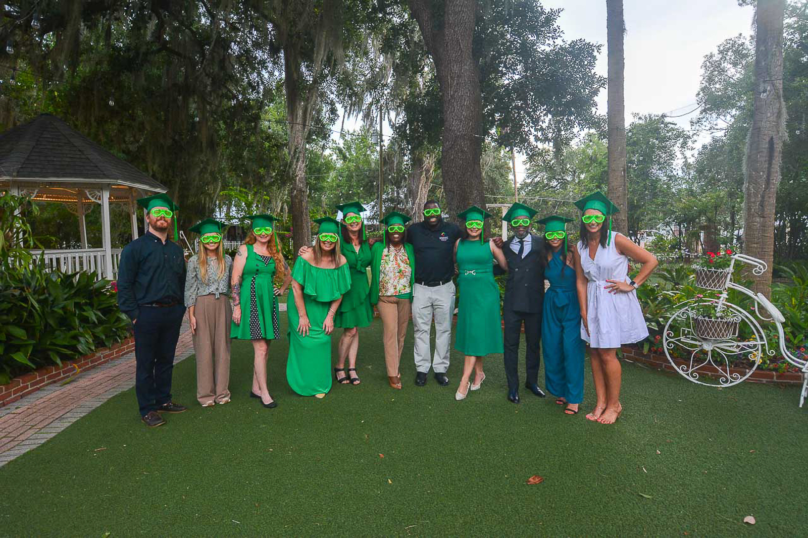 Leadership Gainesville Class 52 Green Team wearing glowing green glasses at their graduation celebration.