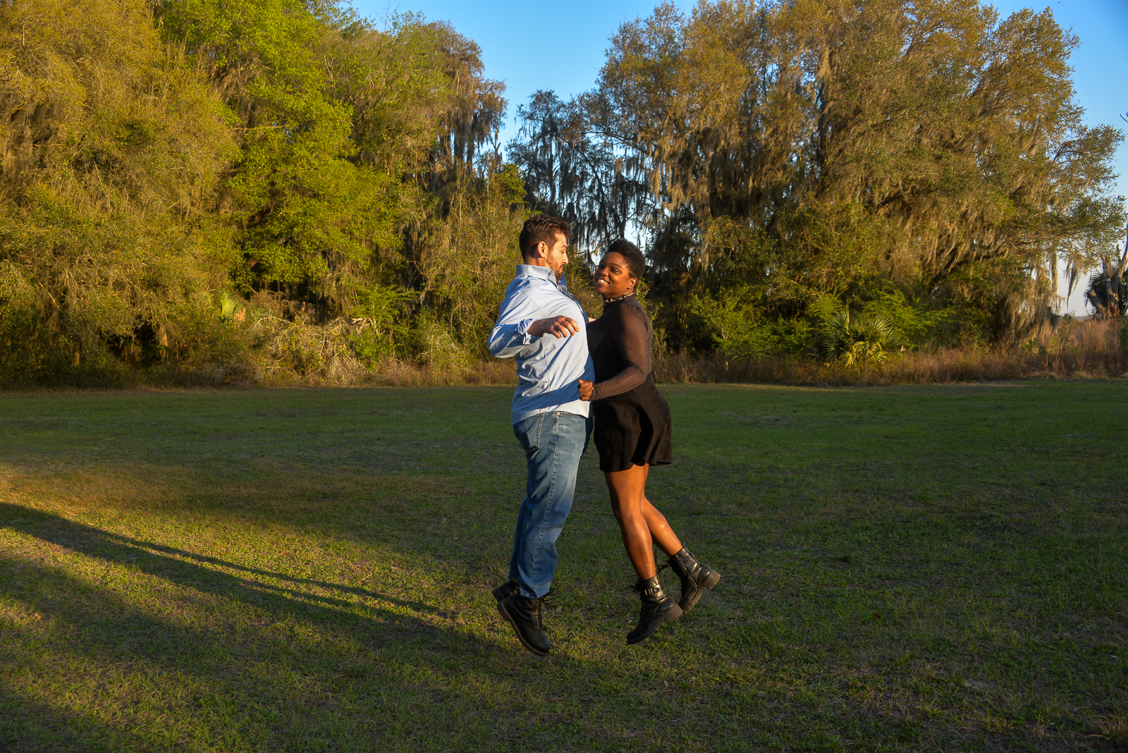 Newly engaged couple celebrating after an outdoor marriage proposal in Gainesville, Florida.