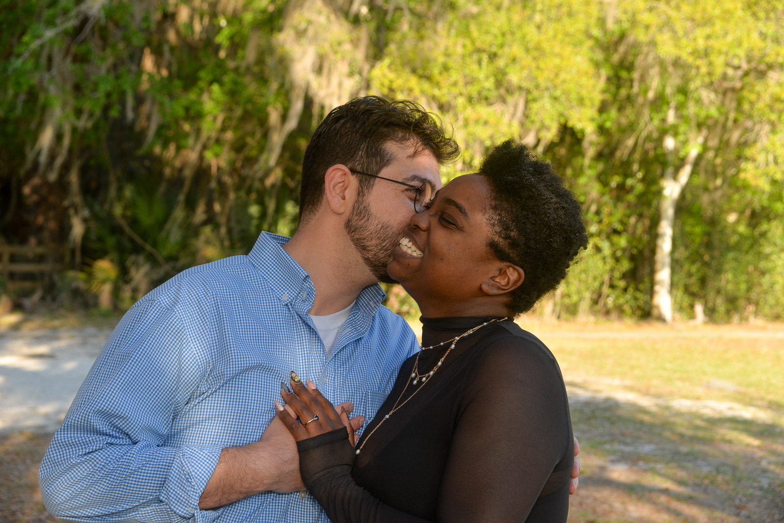 Newly engaged couple smiling together after an outdoor marriage proposal in Gainesville, Florida.