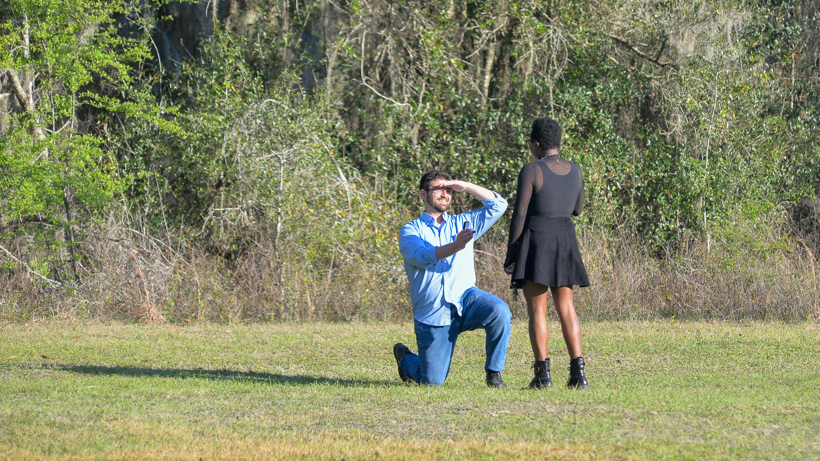 Man proposing on one knee during an outdoor engagement session in Gainesville, Florida.