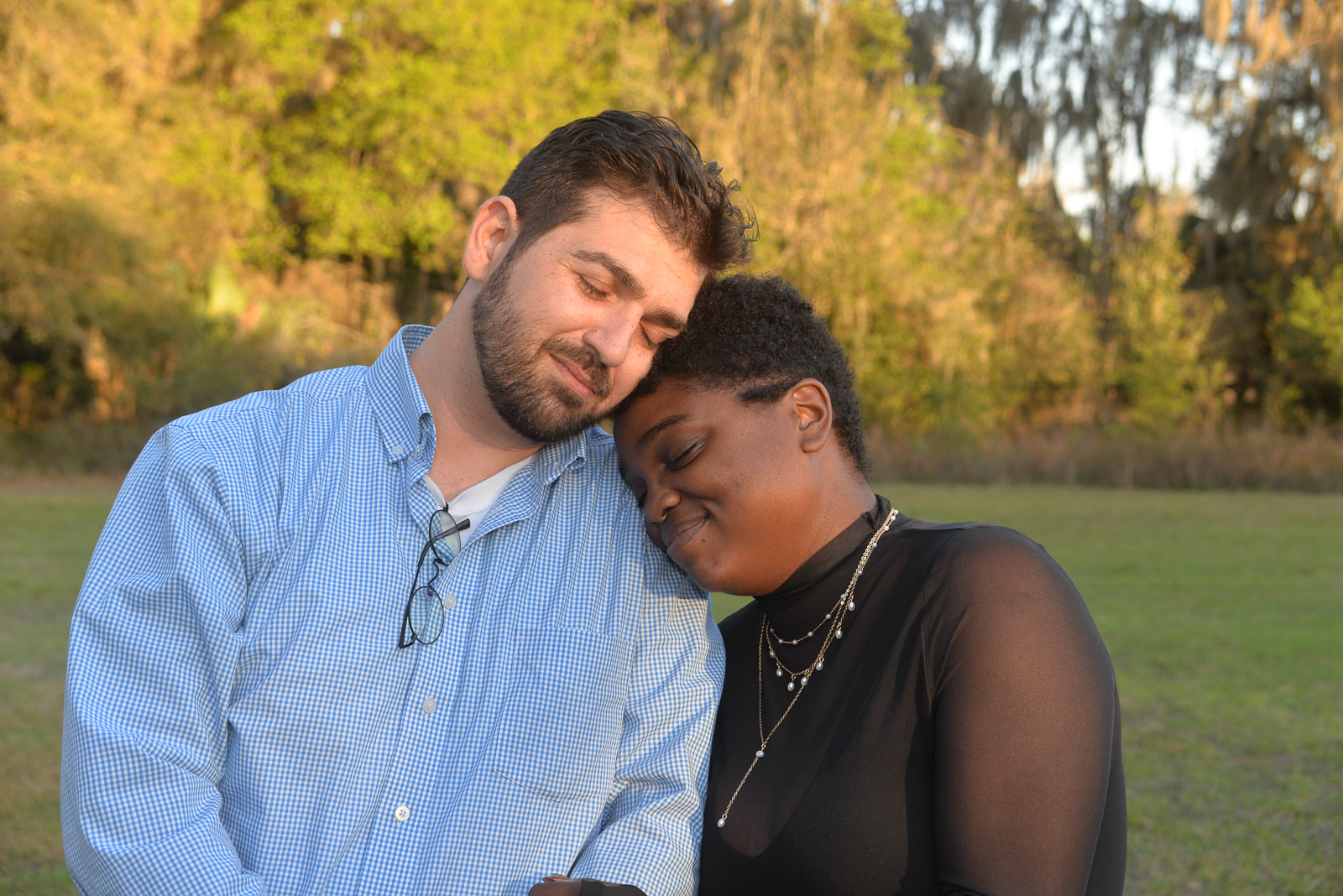 Newly engaged couple sharing a quiet moment after an outdoor marriage proposal in Gainesville, Florida.